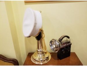 Color Photo of Vincent Dunn's old handlight and a ceremonial bugle.