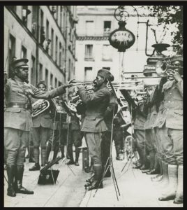 B&W photo of James Reese Europe and the 369th Infantry Regiment Band playing outside an American Red Cross Hospital, Paris