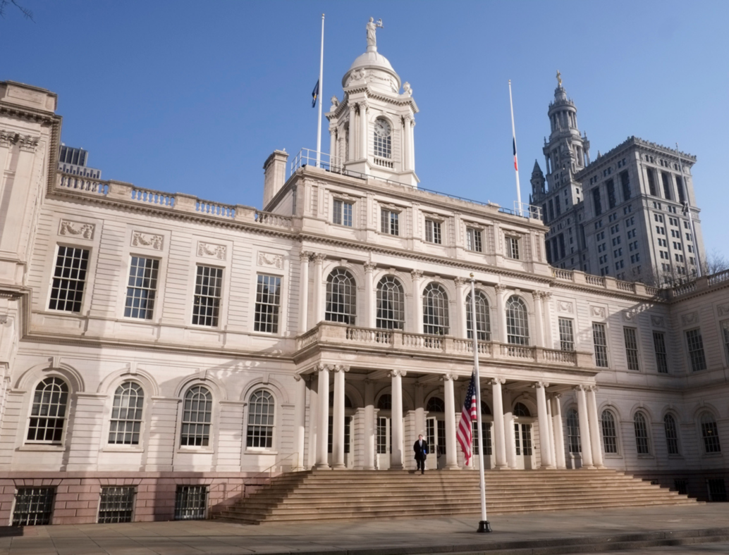 Color Photo of NYC City Hall with Municipal Building in the background. Image via Village Preservation